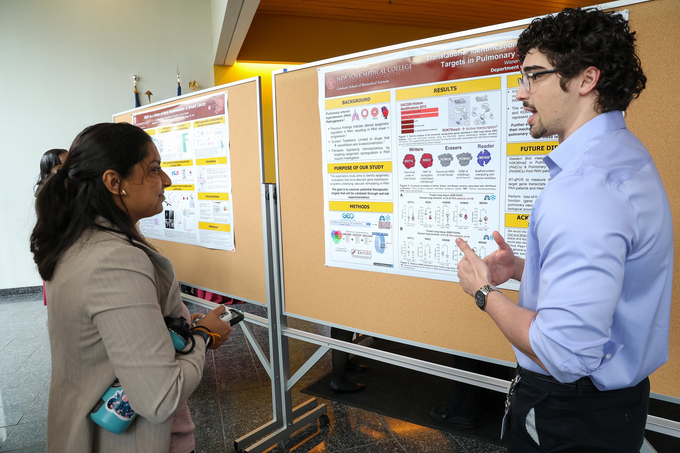 Ayden discussing a research poster